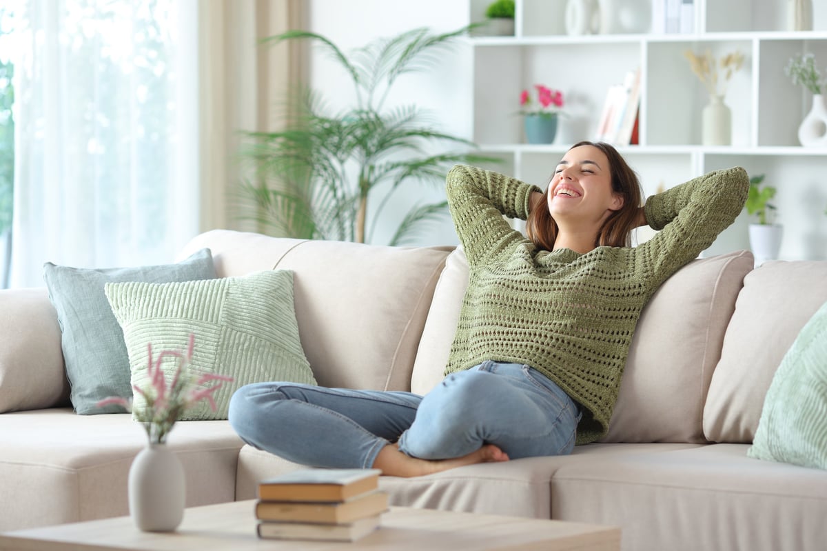 Woman relaxing comfortably in a warm residential living room